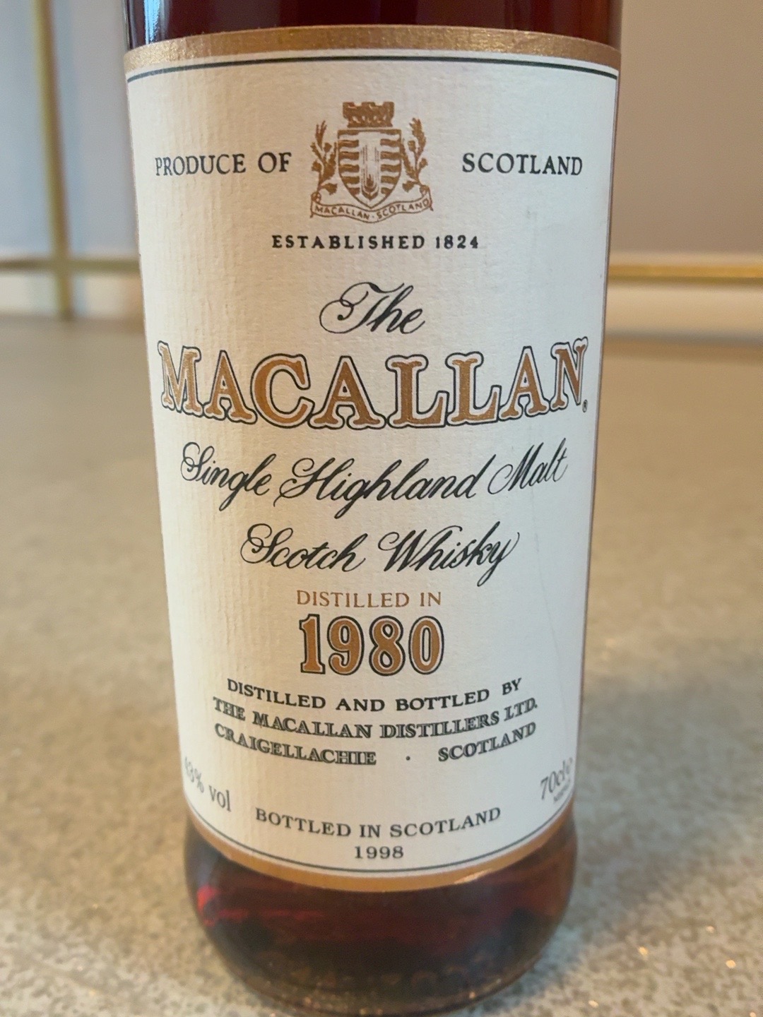 Close view of a Macallan label recording distillation in 1980 and bottling in 1998